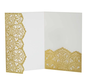 Macro detail of laser-cut glitter paper invitation with elegant hollow pattern