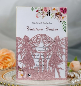 Detail of laser-cut fairy castle invitation with pink glitter finish on white paper