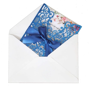 Blue glitter laser cut wedding invitation with satin bow and floral inner card
