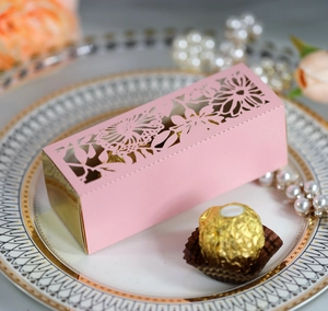 Pink laser-cut rose floral gift box for wedding favors placed on a luxury pearl plate