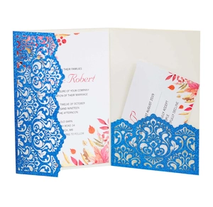 Detail of glitter navy blue laser-cut pocket wedding invitation with floral lace pattern