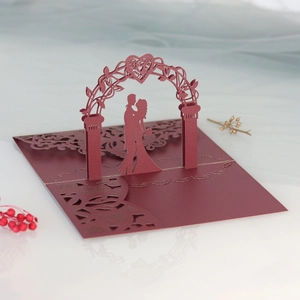 Macro view of 3D laser-cut wedding invitation featuring a romantic couple silhouette