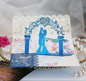 Detail of 3D laser-cut wedding invitation with blue glitter finish and floral inner pop-up