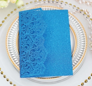 Intricate laser-cut floral pattern on navy glitter cardstock with a shimmering texture