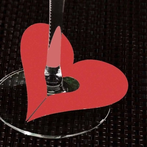 Red heart-shaped laser cut card for wine glass stem decoration at weddings and parties