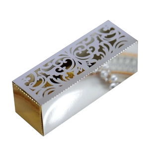 Macro view of silver cutout wedding favor box with elegant European floral patterns