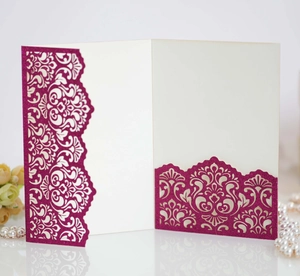 Detail of laser-cut glitter rose red invitation cover with elegant floral hollow patterns