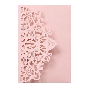 Detailed close-up of laser-cut floral lace pattern on pearlescent pink wedding card