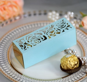 Detailed laser-cut rose pattern on light blue gift box with golden inner tray for weddings