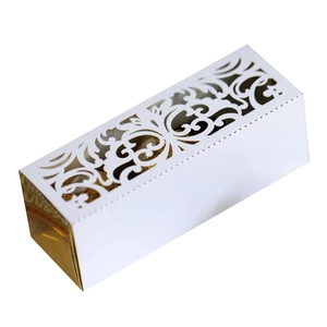 Macro shot of white laser-cut hollow pattern on luxury wedding favor candy gift box