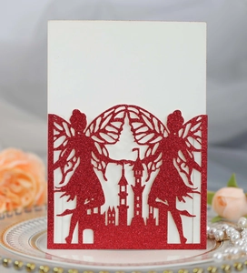 Detail of red glitter laser-cut invitation card with fairy and castle silhouette