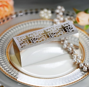 Silver laser-cut hollow cross candy box for wedding and baptism on elegant plate