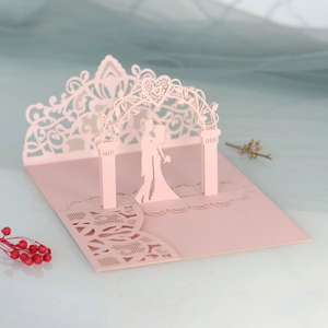 3D pop-up wedding card with pink laser-cut floral arch and romantic couple silhouette