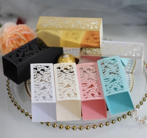 Detail showing laser-cut hollow butterfly wedding candy boxes in multiple elegant colors
