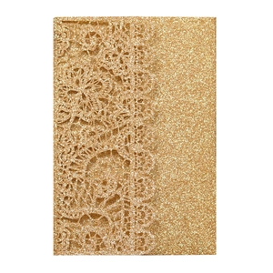 Detail of gold glitter laser cut wedding invitation with intricate floral lace pattern
