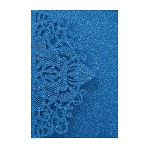 Macro detail of laser-cut royal blue glitter wedding invitation with floral lace pattern