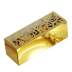 Detail of laser-cut rose patterns on a gold candy box with metallic finish