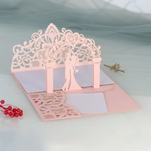 Detailed 3D laser-cut wedding card featuring a romantic couple under a floral arch
