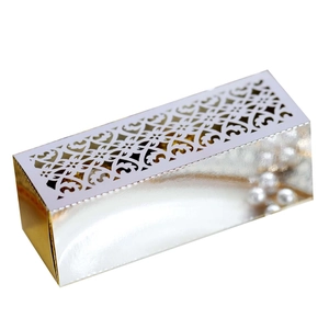 Detail view of pink laser-cut hollow pattern on metallic finish wedding candy gift box