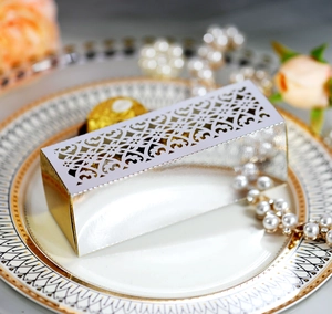 Detailed laser-cut hollow pattern on silver gift box with golden inner paper lining