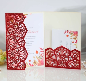 Detail of red glitter laser-cut wedding invitation set with floral inner card and RSVP card