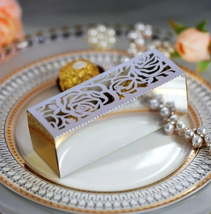 Elegant laser-cut silver rose candy box on decorative ceramic plate with pearls