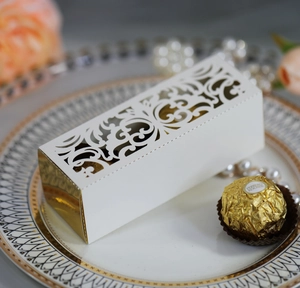 Intricate laser-cut wedding favor box with gold mirror side and floral hollow pattern