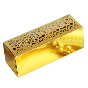 Detailed view of rectangle laser-cut candy box with golden hollow geometric patterns