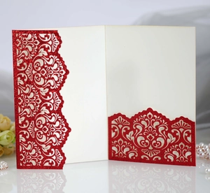 Detail of red glitter card with laser-cut floral pattern for invitations