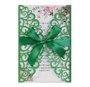Laser cut wedding invitation kit with green glitter sleeve, ribbon and floral inner card