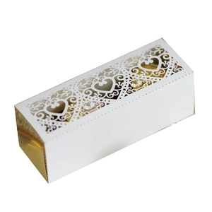 Elegant white and gold laser-cut candy box with intricate floral heart patterns