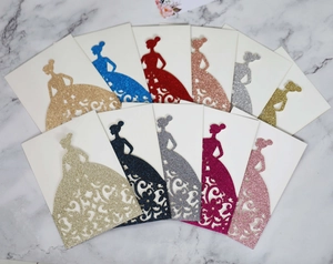 Elegant laser-cut glitter paper wedding invitations with intricate floral gown silhouette