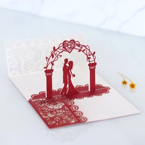 Detailed 3D laser-cut wedding invitation featuring a romantic couple and glitter paper