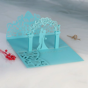 Detail of laser cut 3D wedding invitation featuring a romantic couple under a floral arch