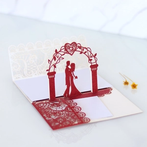Detailed 3D laser-cut wedding invitation featuring heart silhouette and red glitter paper