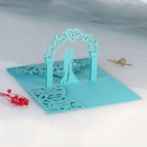 Detailed laser-cut 3D pop-up wedding invitation featuring a couple in light blue