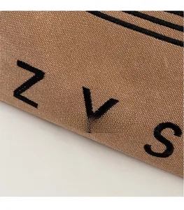 Close-up of khaki canvas tote with black ZVS embroidery and durable ribbed texture