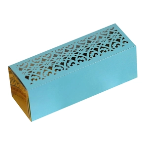 Detail view of laser-cut hollow floral pattern on a blue and gold paper gift box