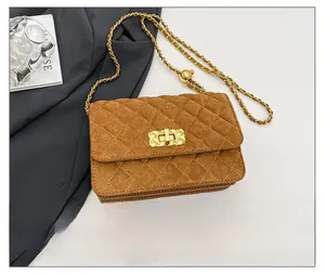 Brown suede quilted crossbody bag with gold chain strap and smartphone for size reference