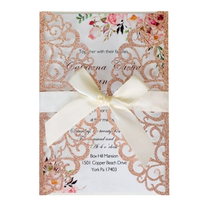 Elegant rose gold glitter laser-cut wedding invitation with cream silk ribbon bow decoration