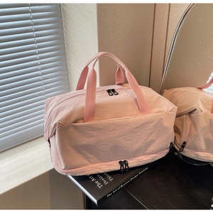 Pink waterproof nylon travel bag with a separate shoe compartment and large capacity