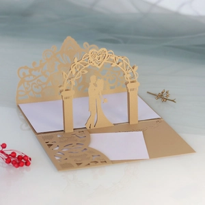 Macro detail of laser-cut 3D wedding invitation with gold pearlescent paper textures