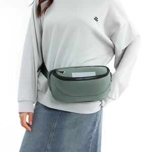 Detailed view of sage green waterproof waist bag featuring reflective safety patch