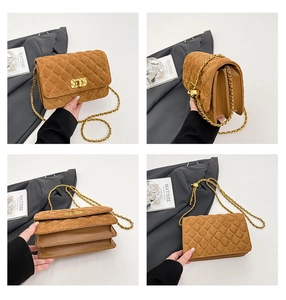 Close-up of brown suede quilted crossbody bag with gold clasp and multi-layer structure
