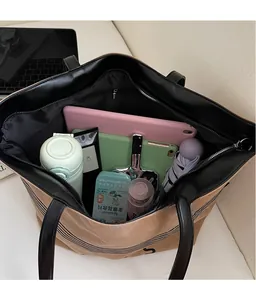 Spacious canvas tote bag interior showing capacity for iPad, bottle, and umbrella