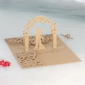 Detailed laser-cut 3D wedding invitation card with golden bride and groom silhouette