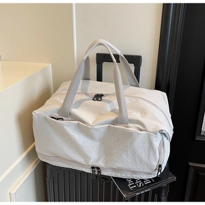 Detail of large capacity travel bag with trolley sleeve on luggage for commuting