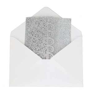 Elegant laser cut wedding invitation with silver glitter lace detail and white envelope