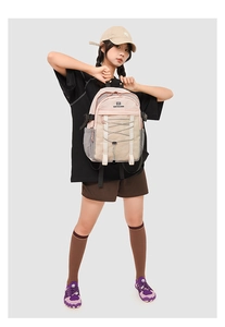 Detail of waterproof nylon backpack showing elastic cords and mesh side pockets