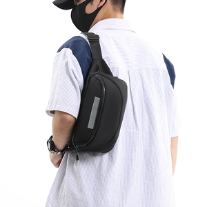 Detail view of the black waterproof chest bag with a safety reflective strip and zippers